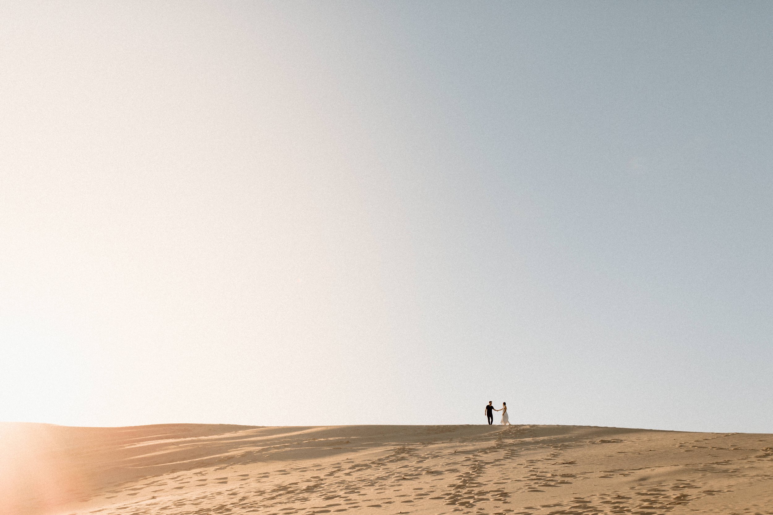 Sunset engagement session at silver lake sand dunes in Michigan