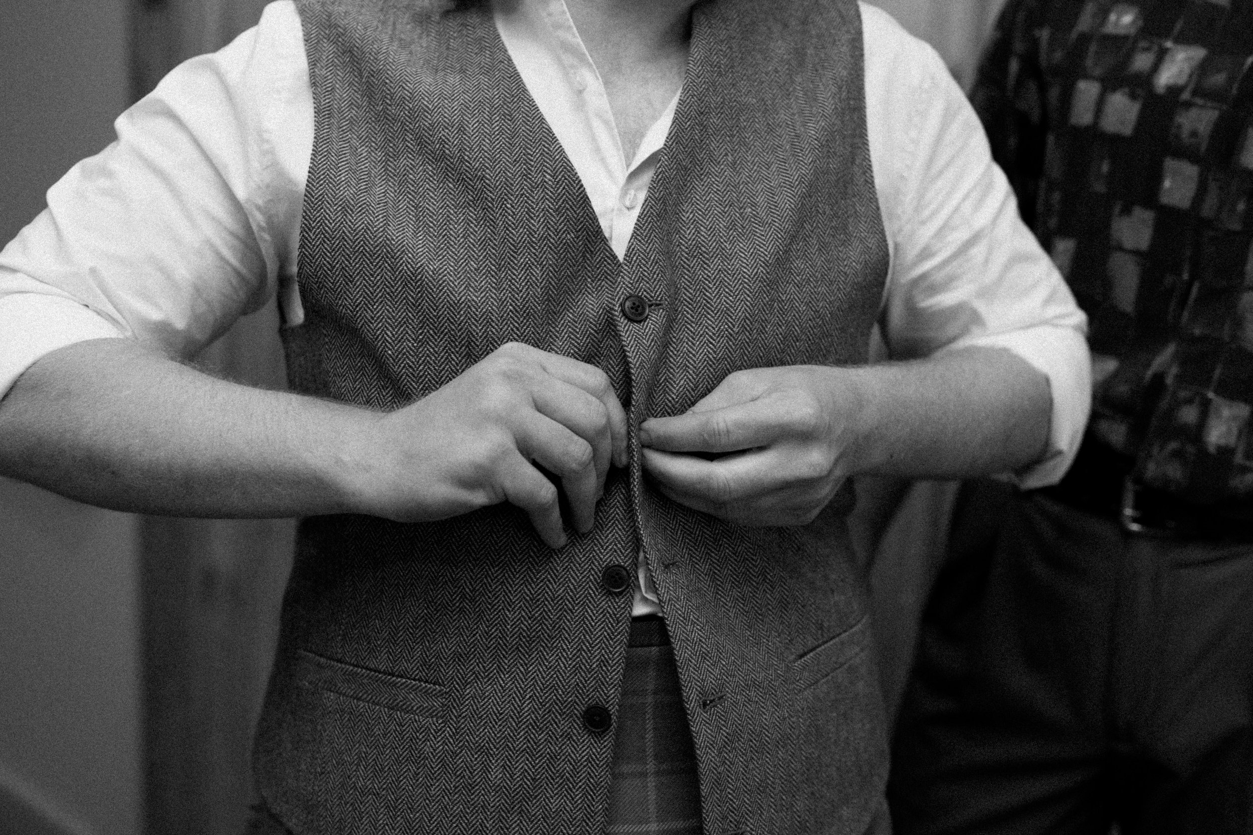 Buttoning thrifted vest for Irish ceremony