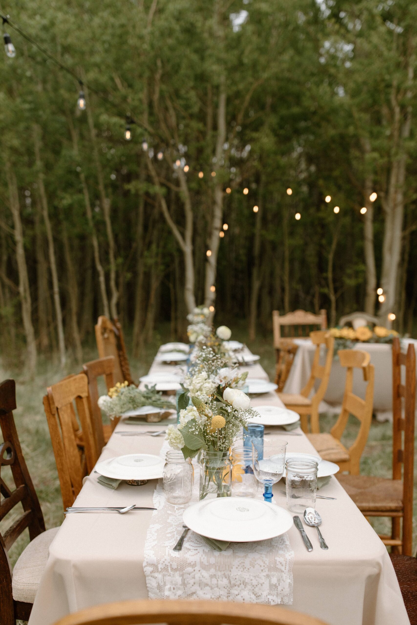 Completely thrifted wedding table settings for backyard wedding in Fairplay, Colorado