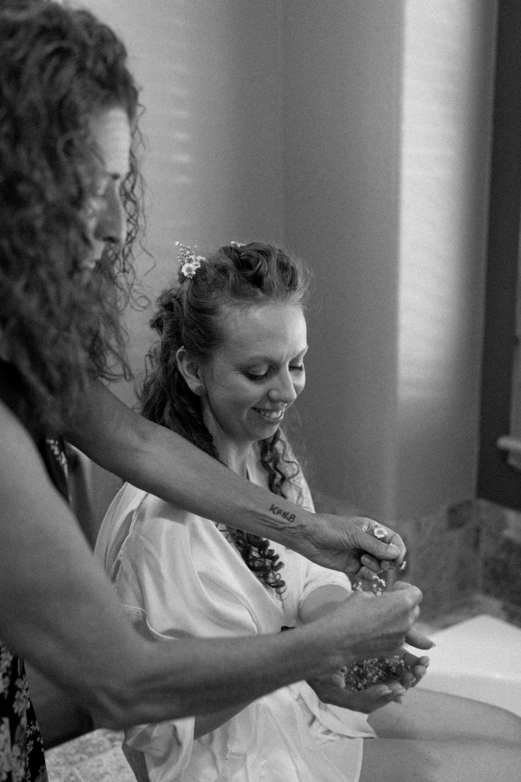 Bride getting flowers in her hair