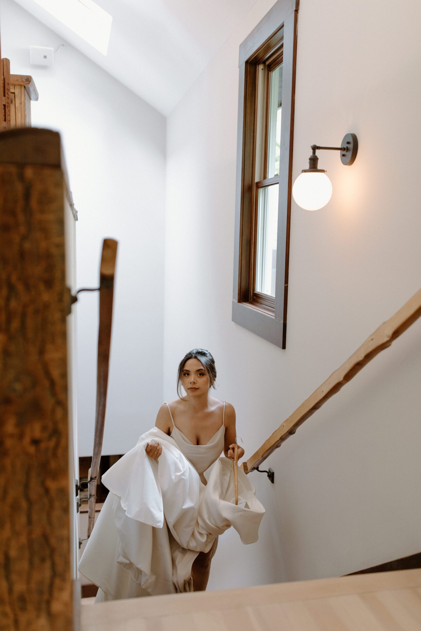 Bride walking up stairs at Emerson House to get ready