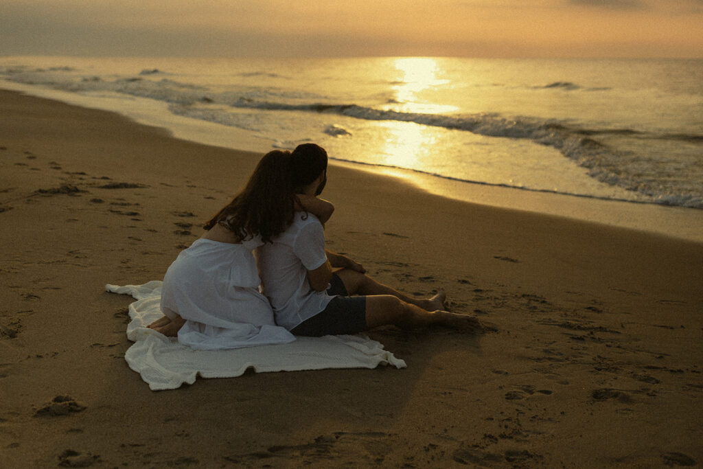 Couple watching sunrise at Folly Field Beach in South Carolina